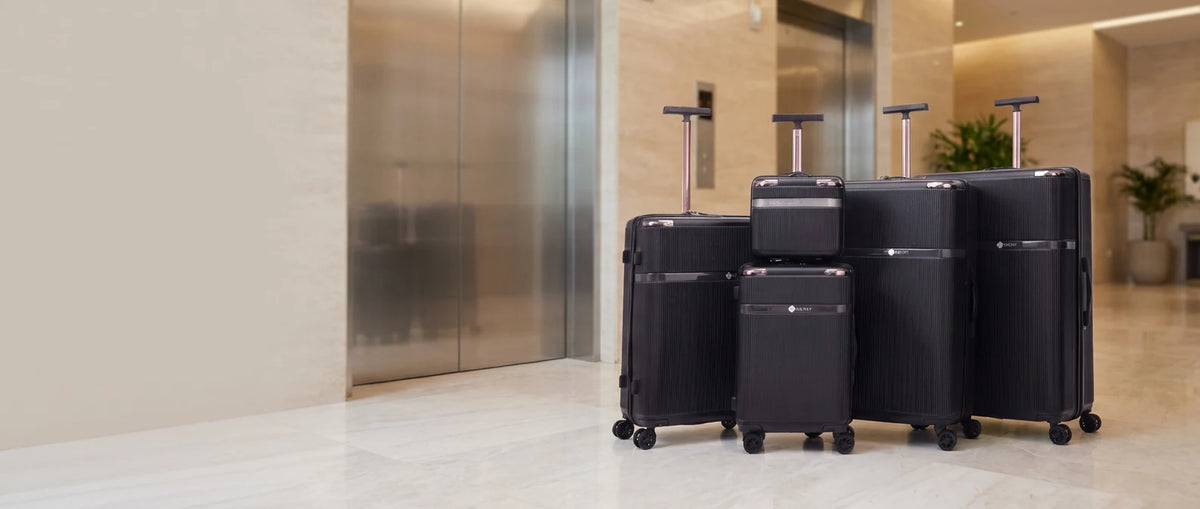 Grant Fluted hard shell luggage set in a hotel lobby