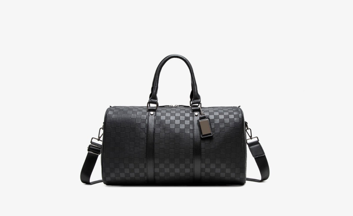 Ezzyrol under seat weekend holdall in a checkerboard pattern, charcoal, shown with its detachable shoulder strap