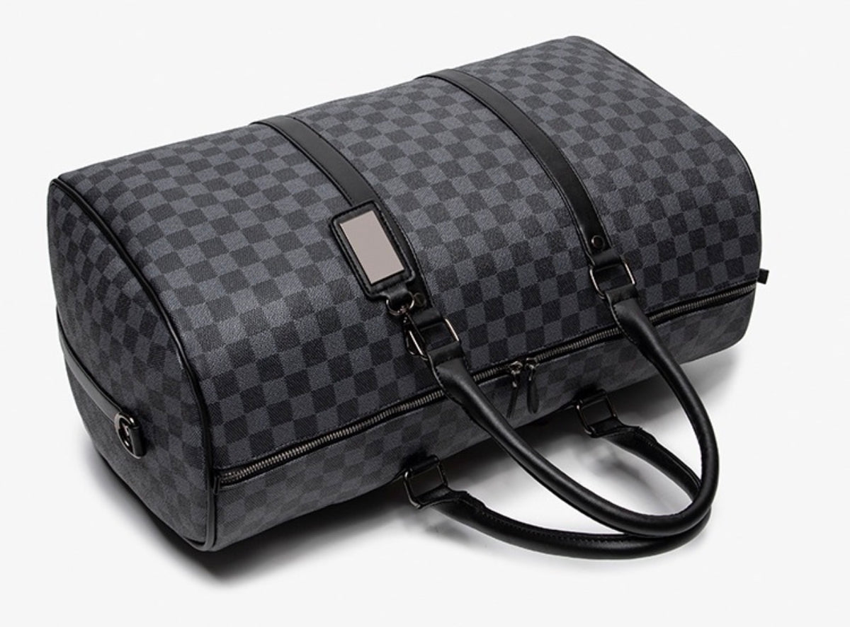 Ezzyrol under seat weekend holdall in a checkerboard pattern, charcoal, seen from the end showing the rounded profile
