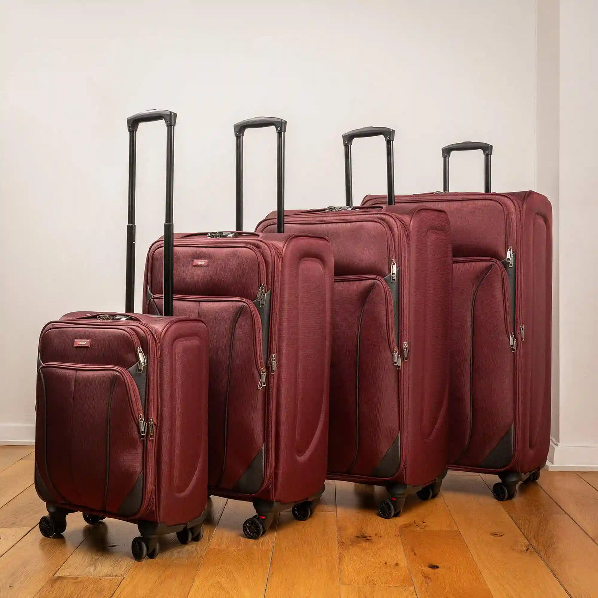 Ezzyrol Shuttle soft shell luggage, set of four in burgundy, standing on an oak floor