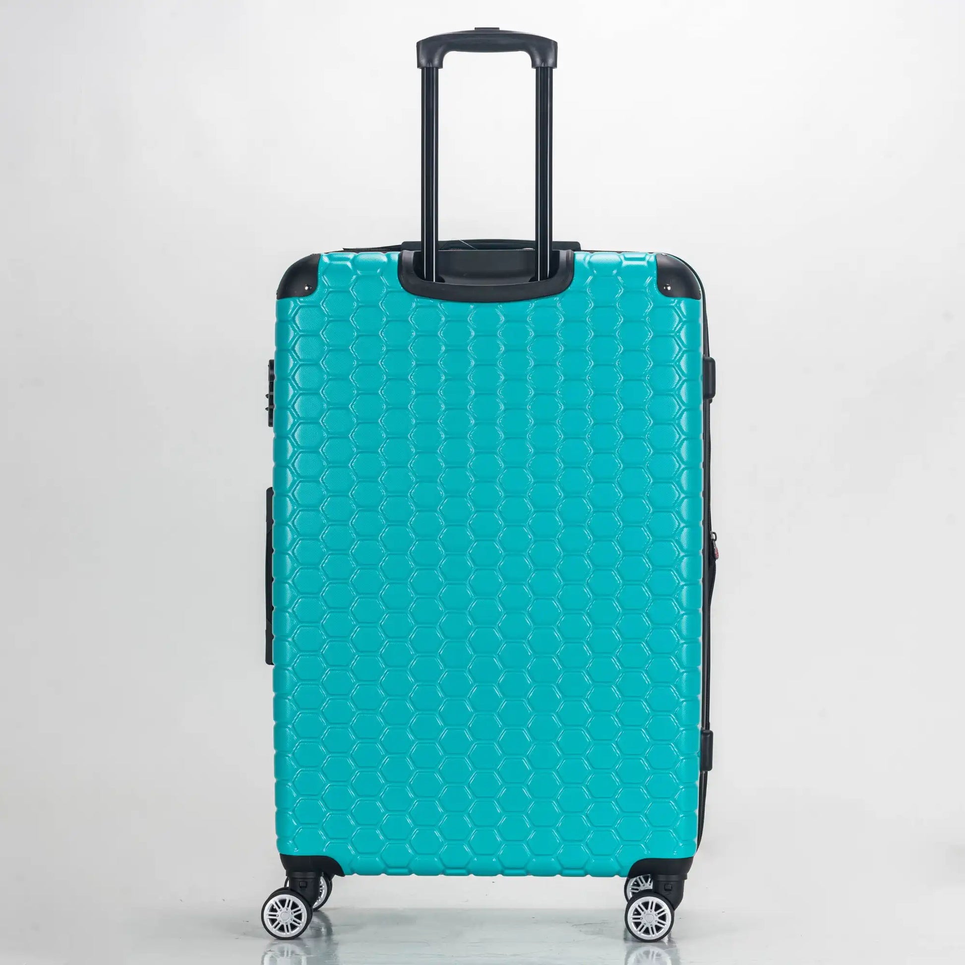 Turquoise suitcase with a textured pattern on a white background