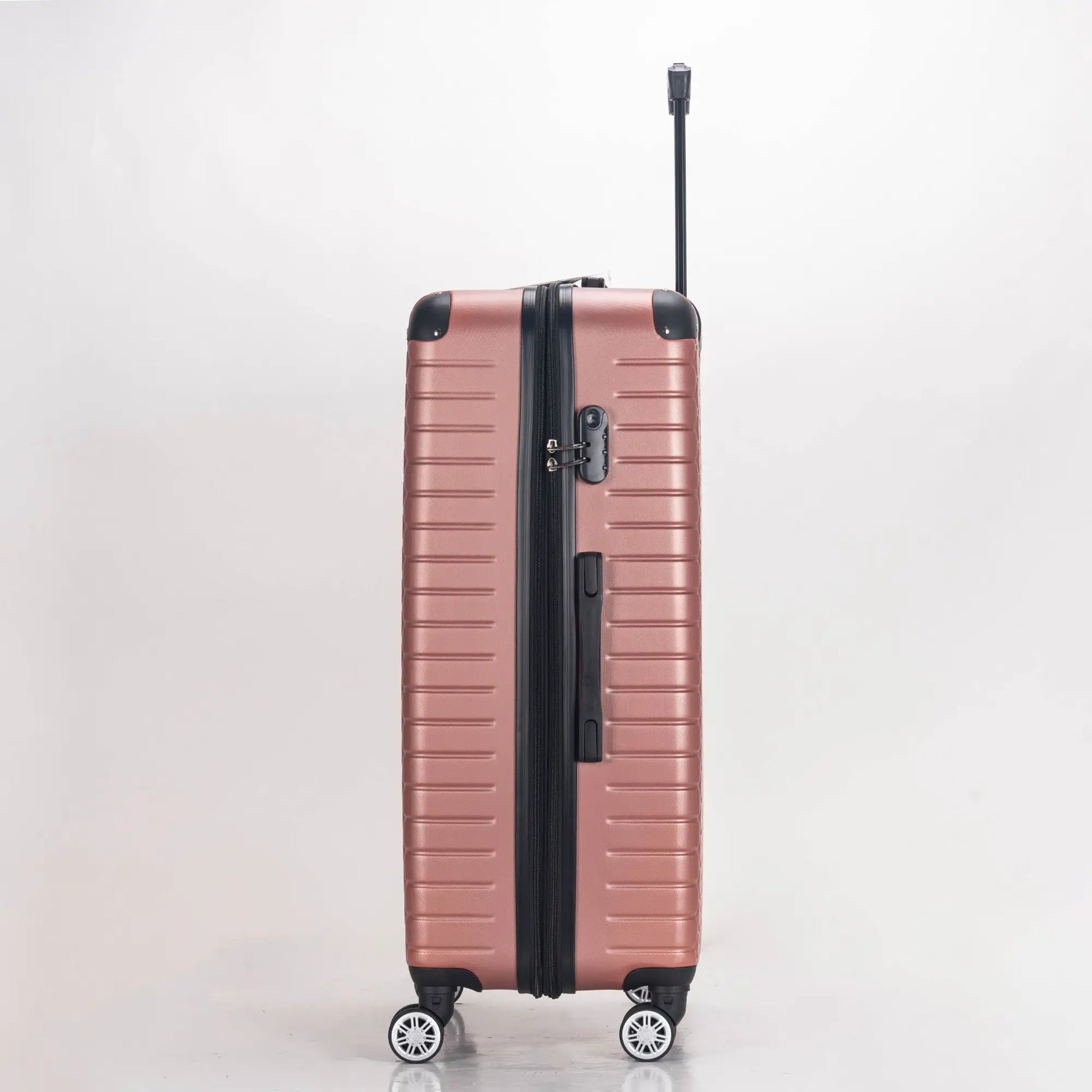 Rose gold suitcase with black handle and wheels on a light gray background
