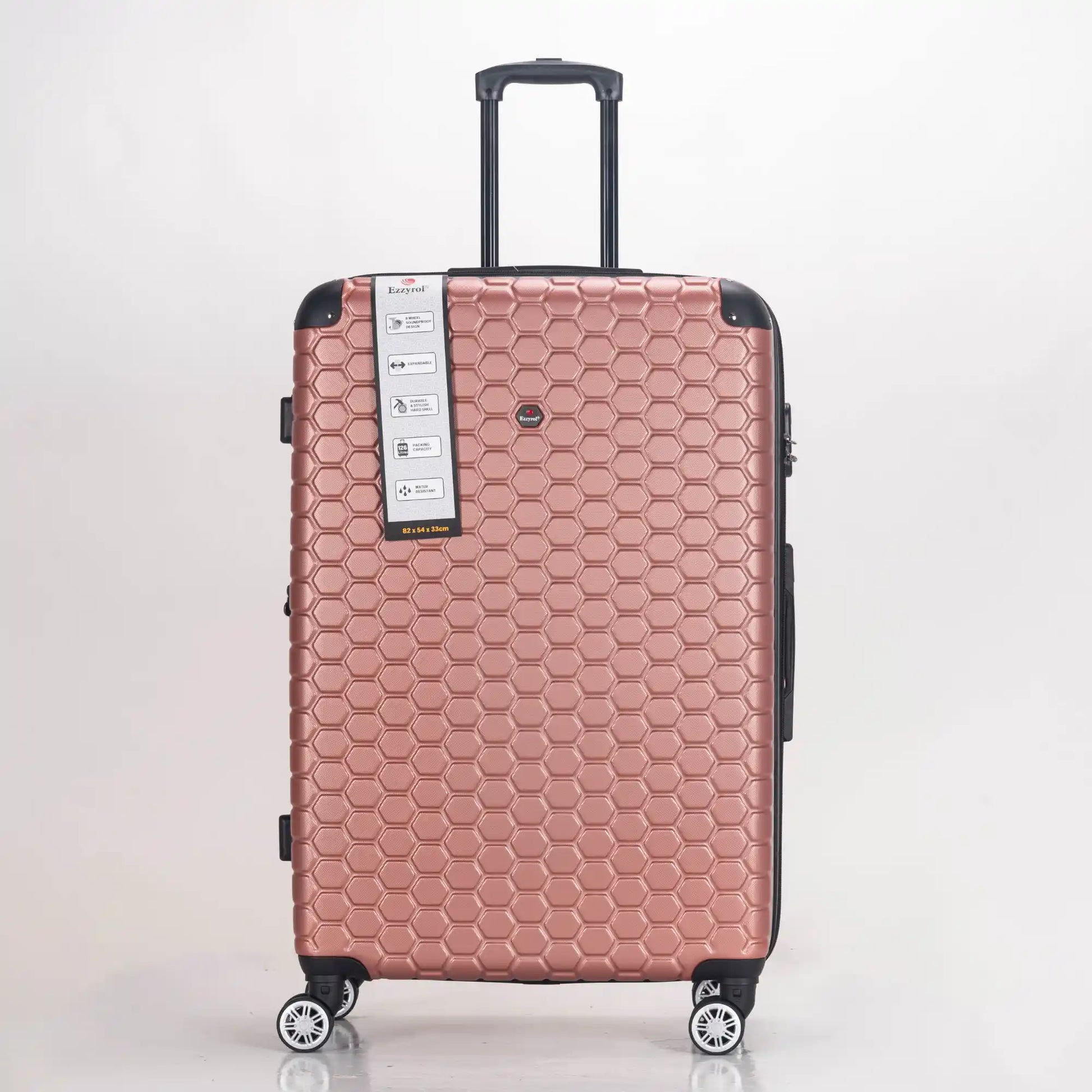 Rose gold suitcase with honeycomb pattern on a light gray background