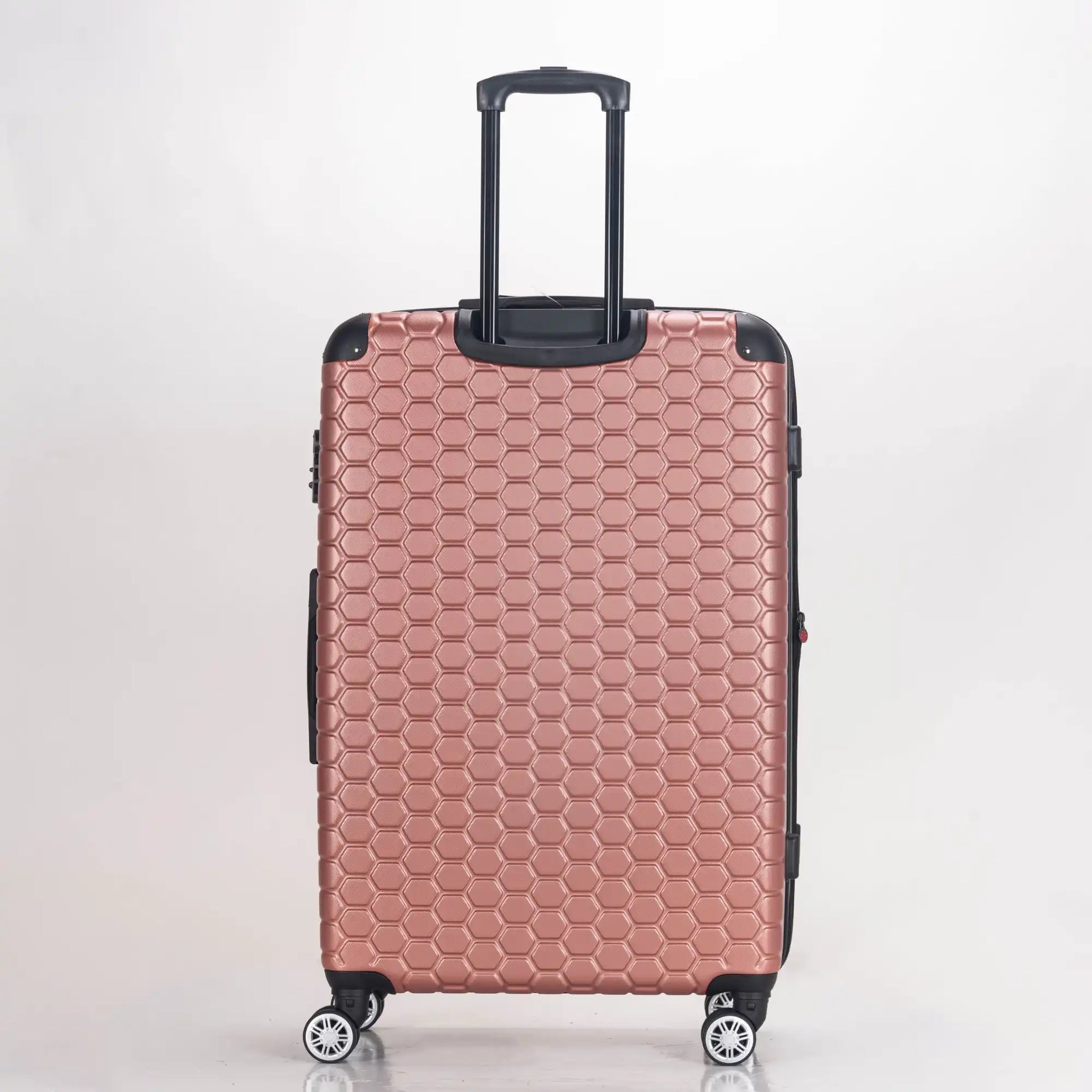 Rose gold suitcase with honeycomb pattern on a white background