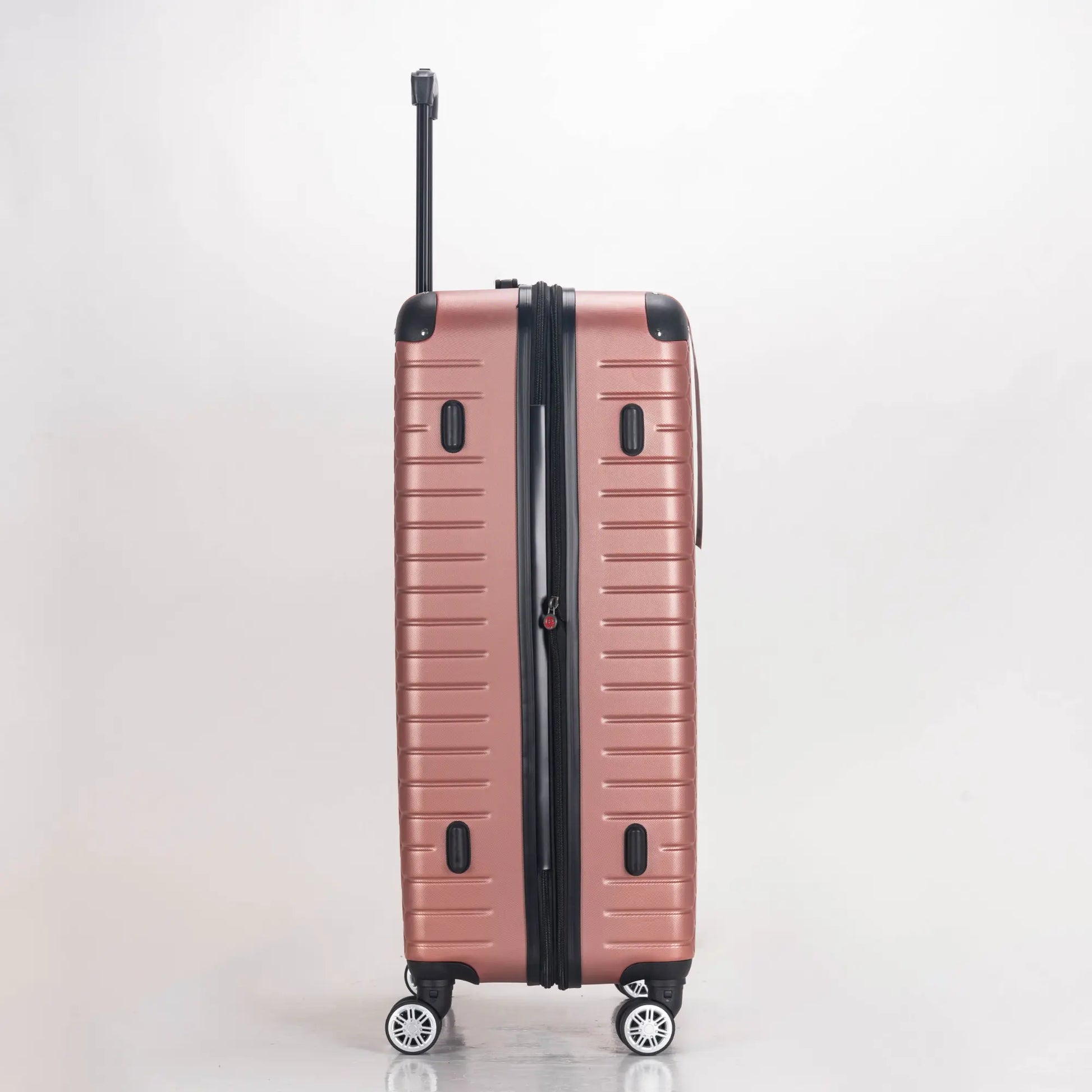 Rose gold suitcase with black handle and wheels on a light gray background