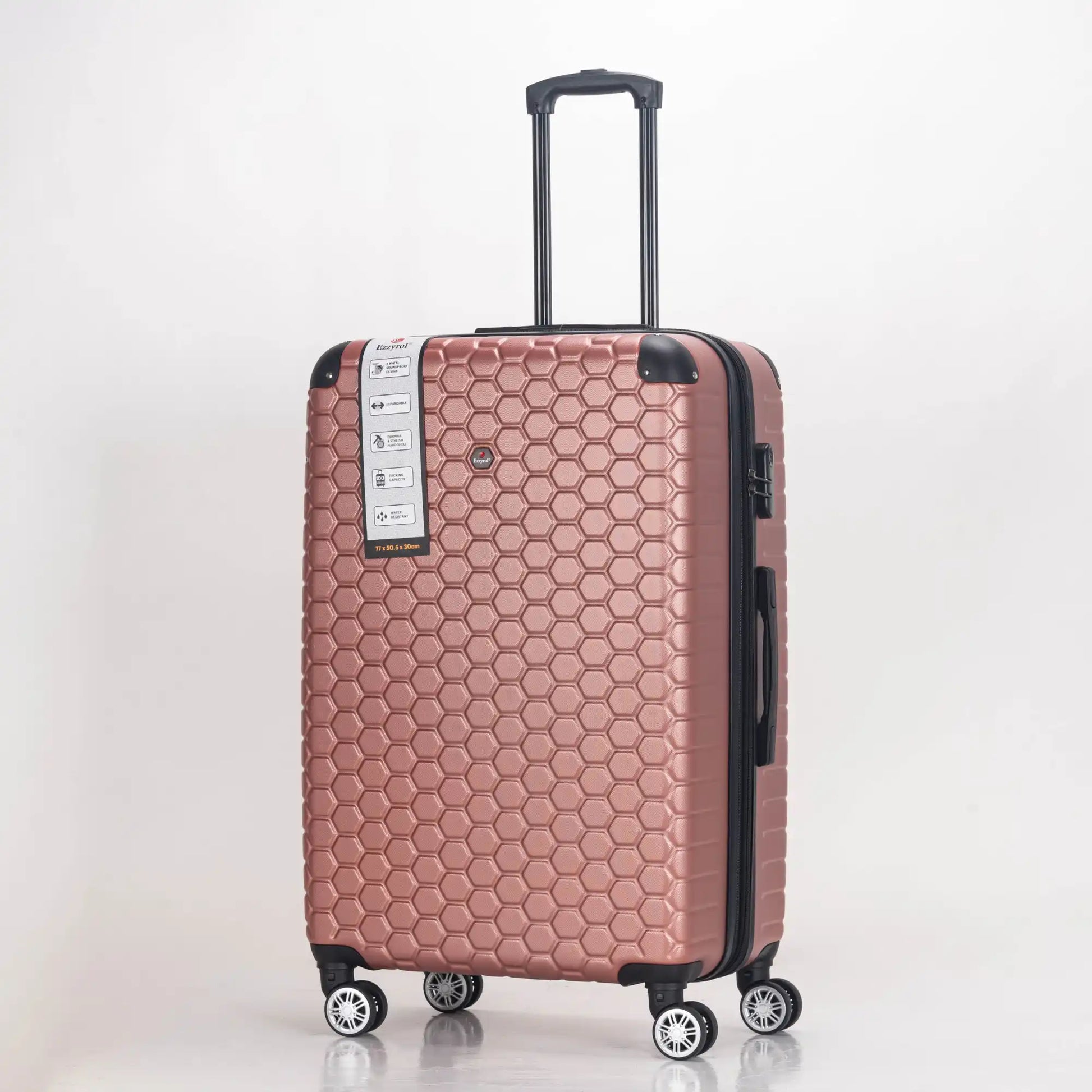 Rose gold suitcase with honeycomb pattern on a light gray background