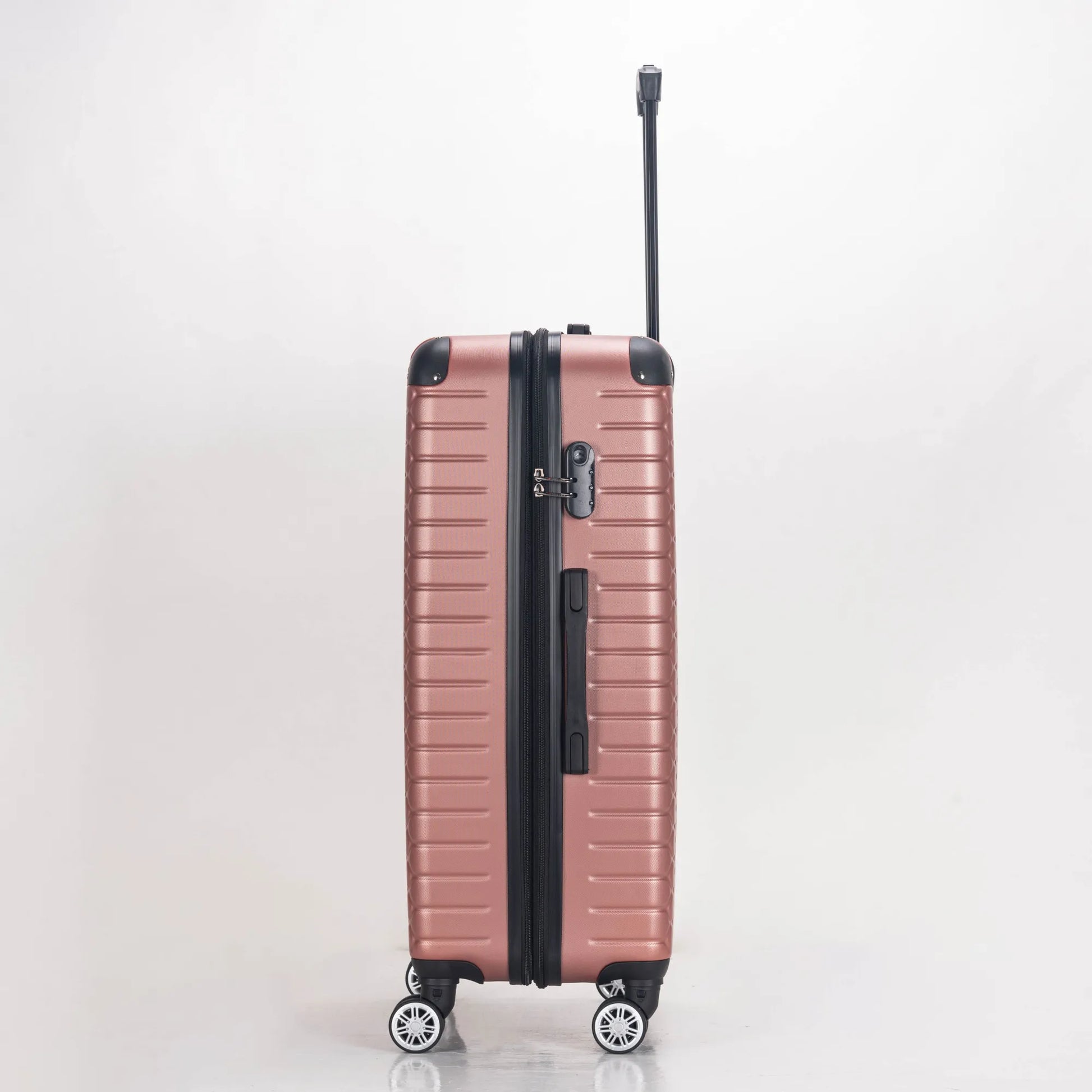 Rose gold suitcase with black handle and wheels on a light gray background