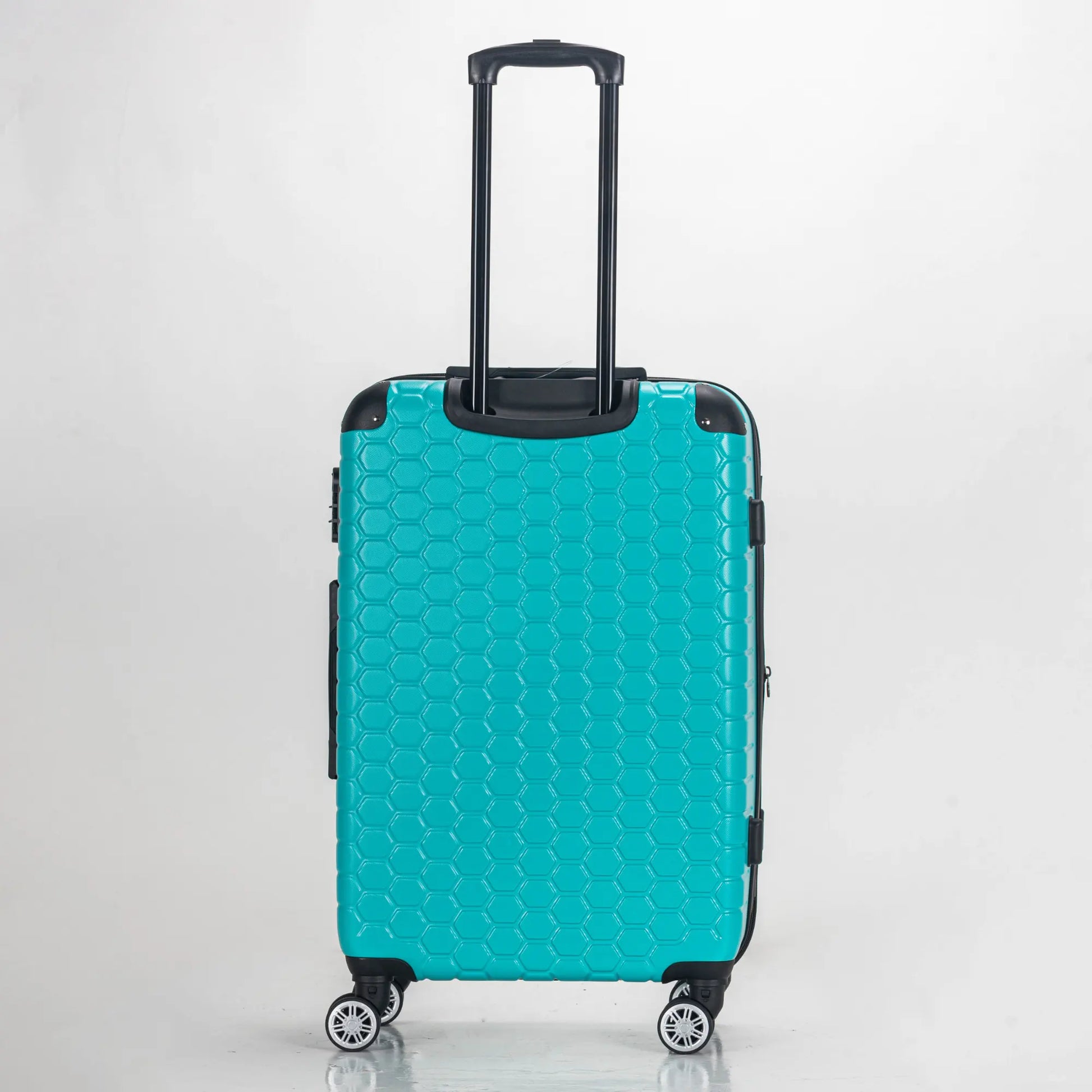 Turquoise suitcase with a honeycomb pattern on a light gray background