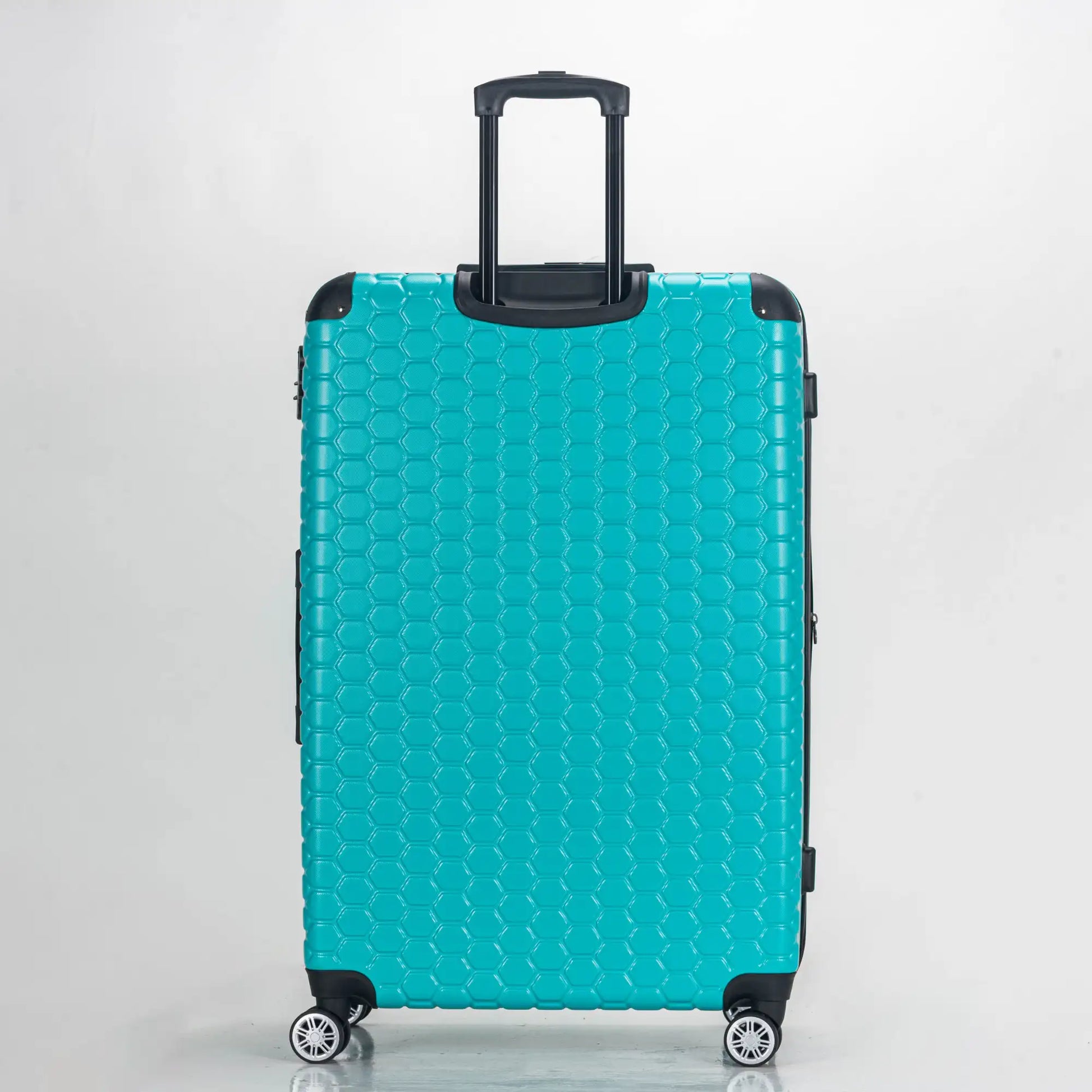 Turquoise suitcase with a textured pattern on a light gray background