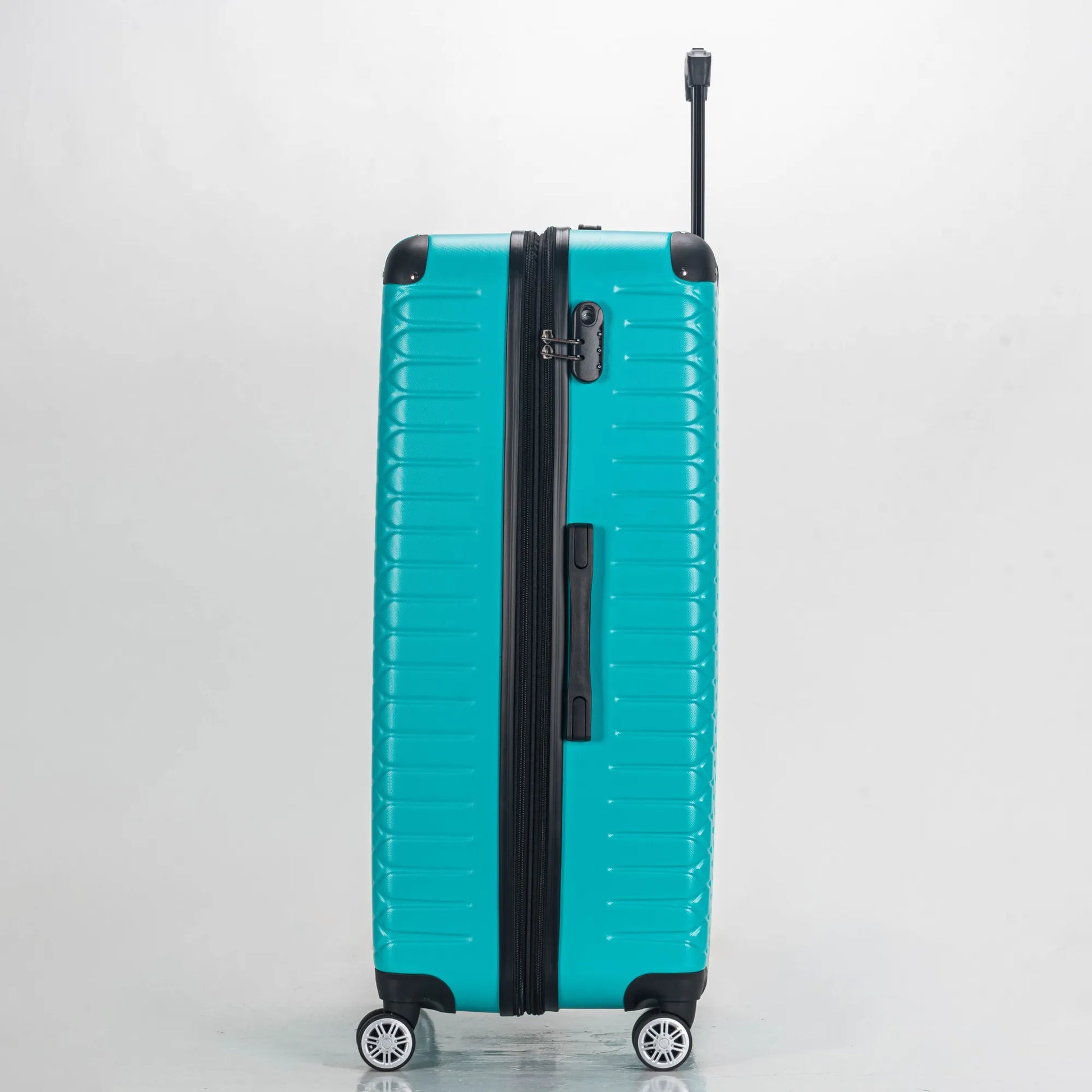 Turquoise suitcase with black handle and wheels on a light gray background