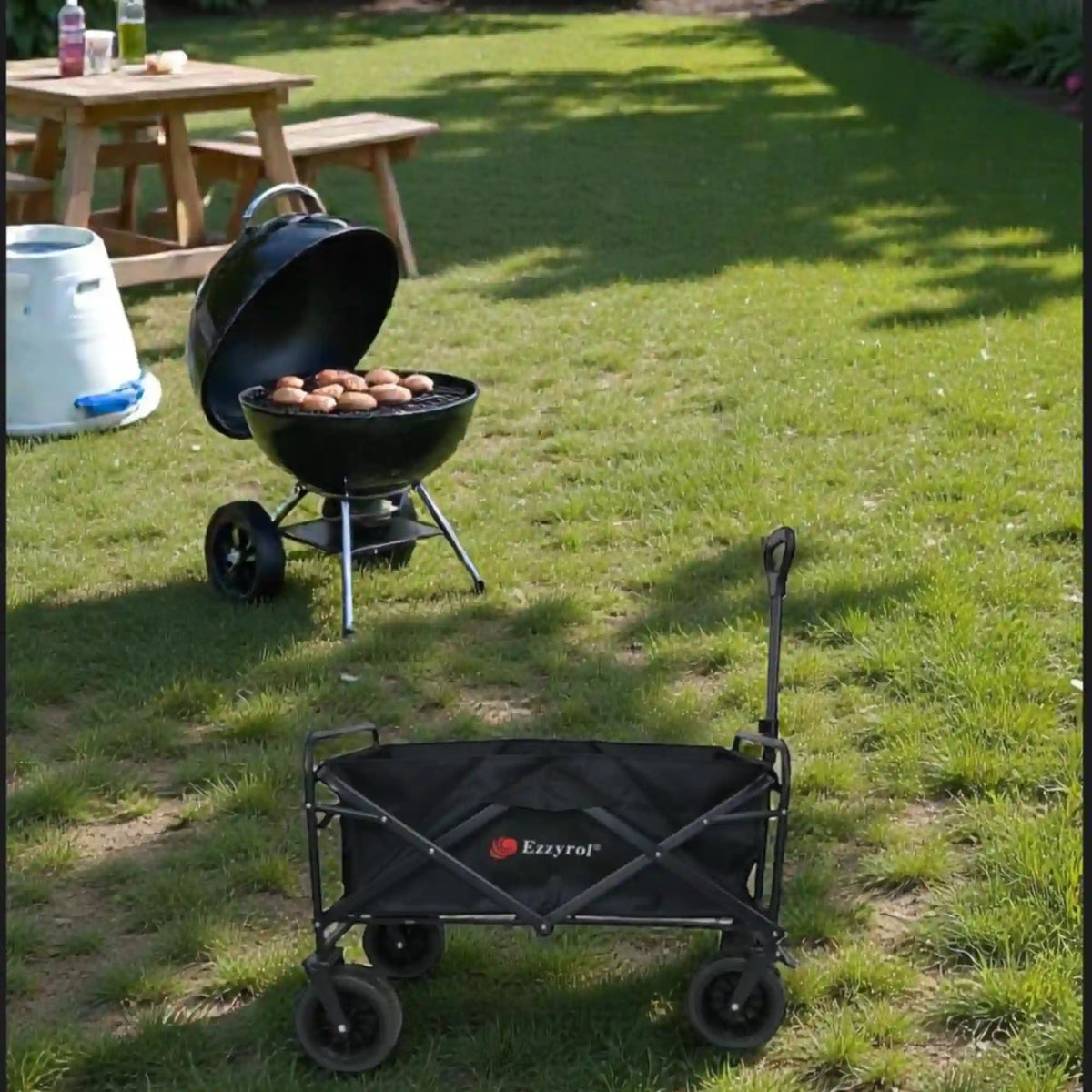 Black folding wagon on grass with a grill and eggs nearby