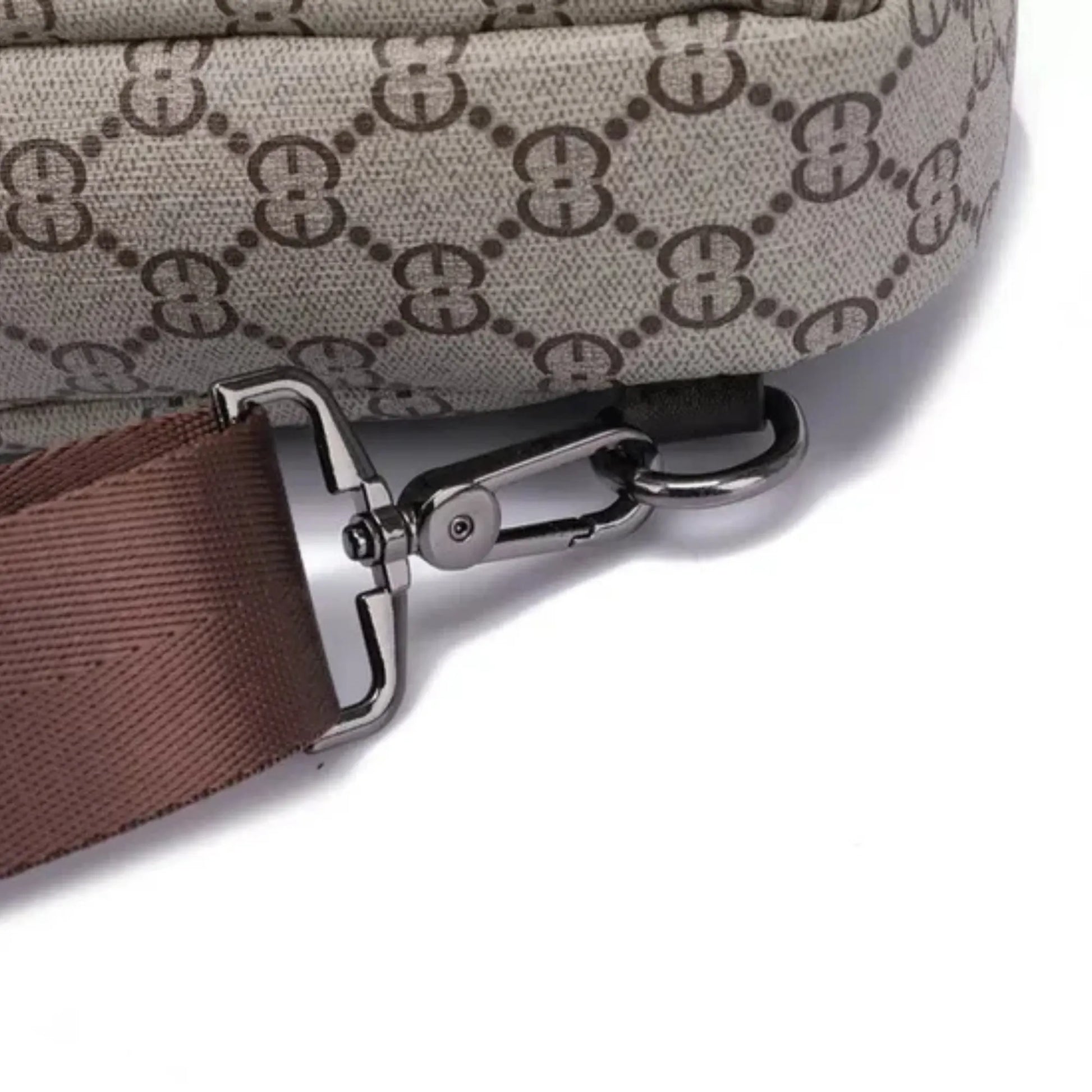 Close-up of a bag strap with a clasp on a light gray background