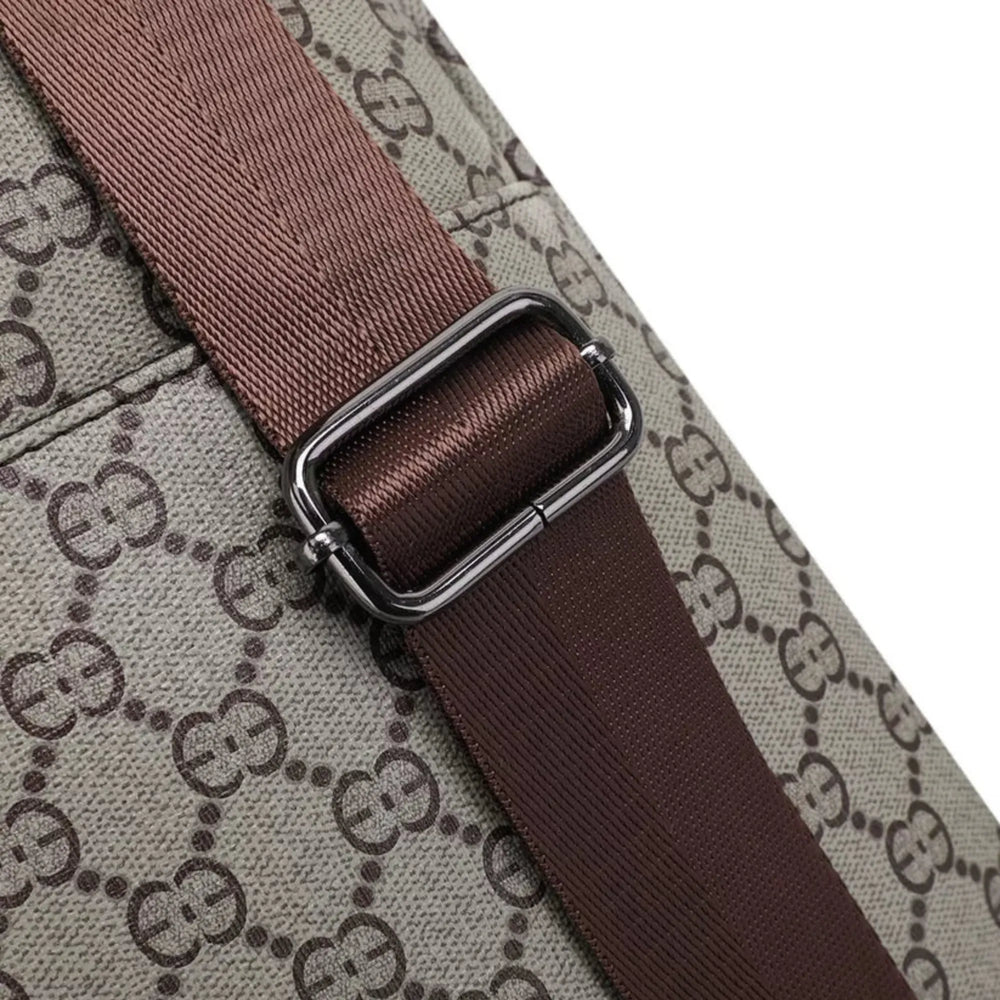Close-up of a brown strap on a Gucci-patterned surface