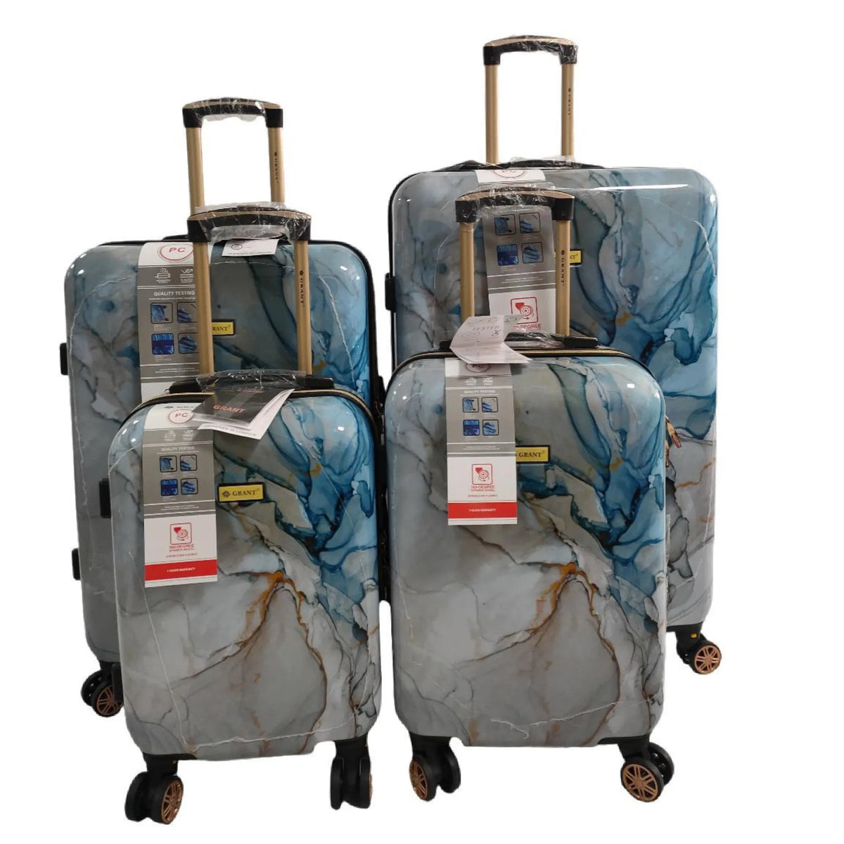 Set of three marbled patterned suitcases on a white background