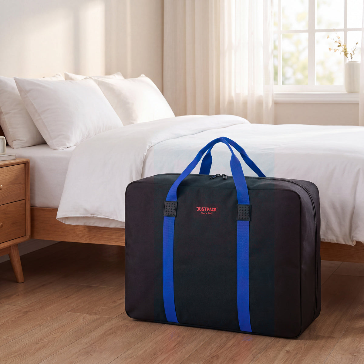 Black with Blue Straps Stowaway storing bedding by the bed