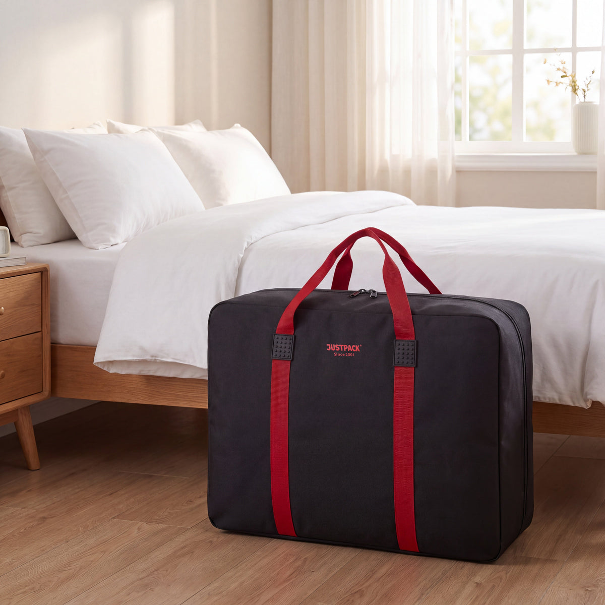 Black with Red Straps Stowaway storing bedding by the bed