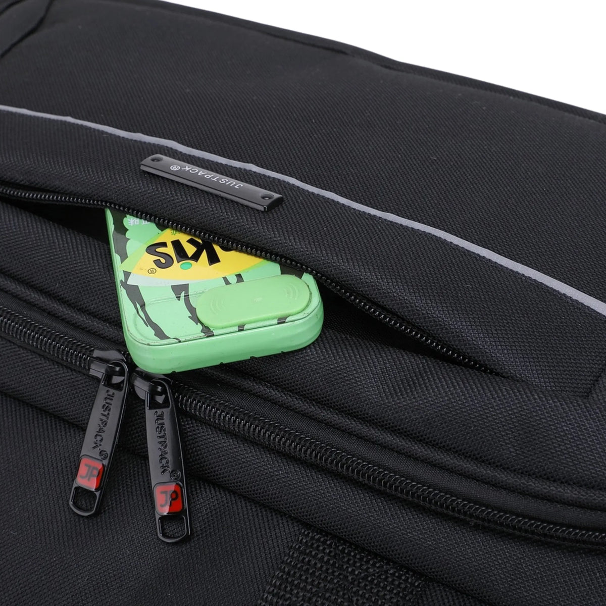 Black suitcase with a green keychain attached to one of the zippers