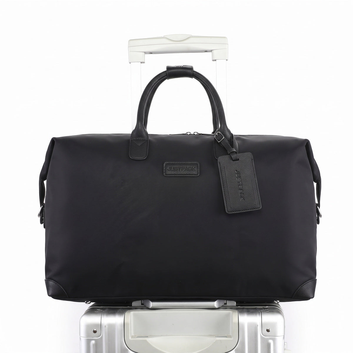 JustPack Mayfair weekender slid onto the handle of a wheeled suitcase through its trolley sleeve