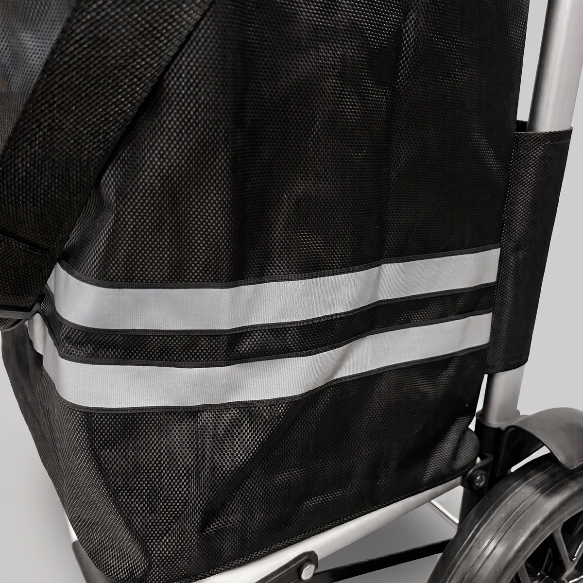 Close-up of the reflective stripes and mesh side panel on the black Ezzyrol trolley