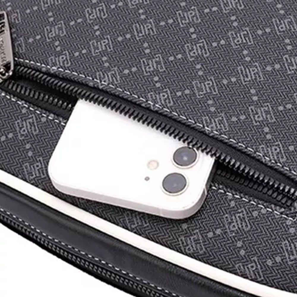 Close-up of the monogram print fabric and main zip, with a phone slipping into the pocket