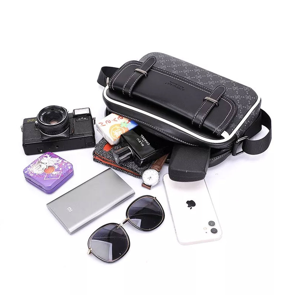 Classic crossbody bag in black with a monogram print shown beside everything it holds: a camera, a wallet, a power bank, sunglasses and a phone