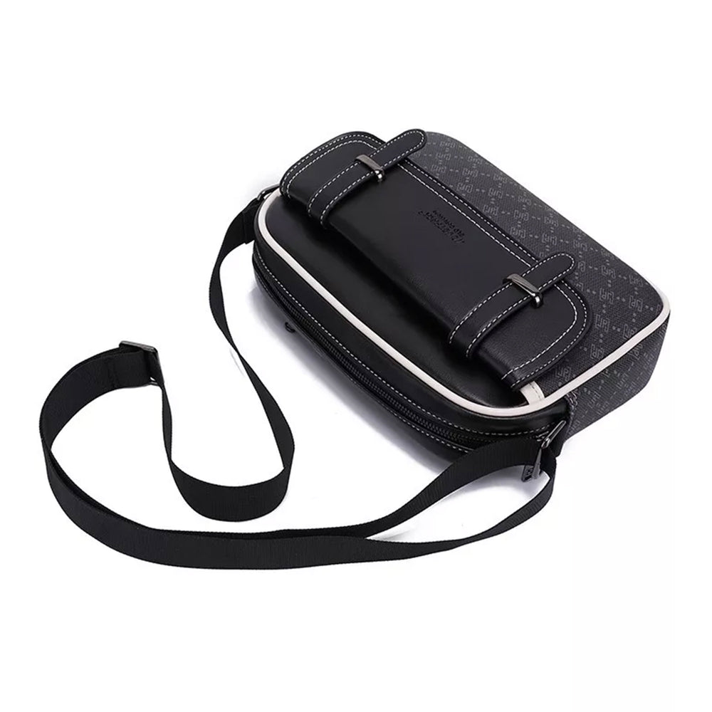 Classic crossbody bag in black with a monogram print with its webbing shoulder strap coiled beside it