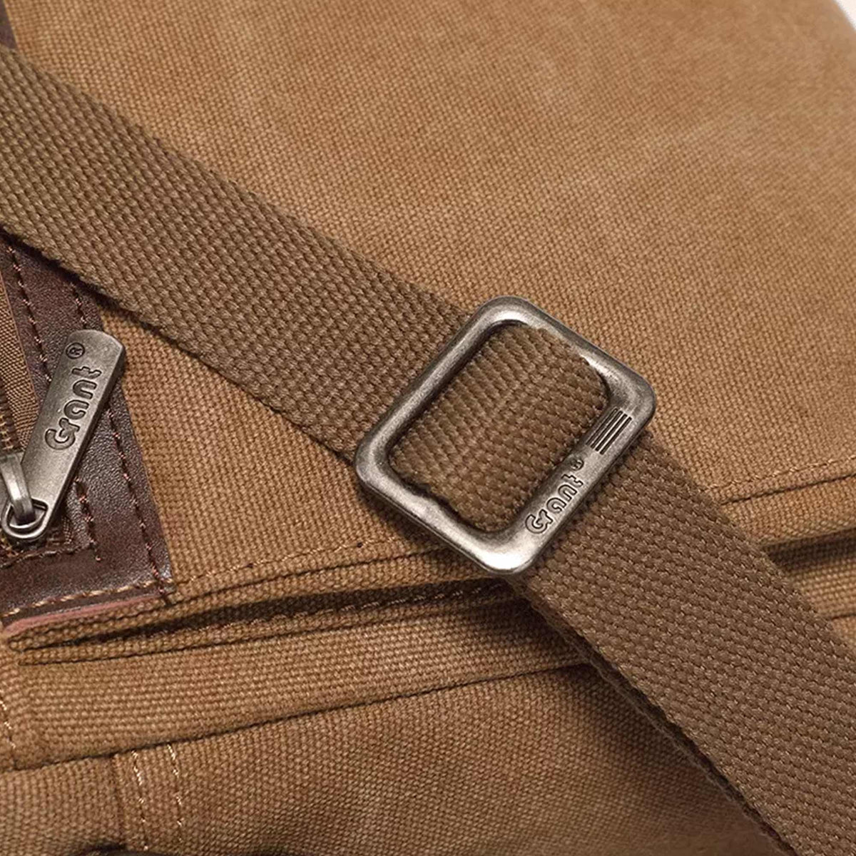 Close-up of the metal strap slider on the Grant canvas crossbody bag, stamped Grant