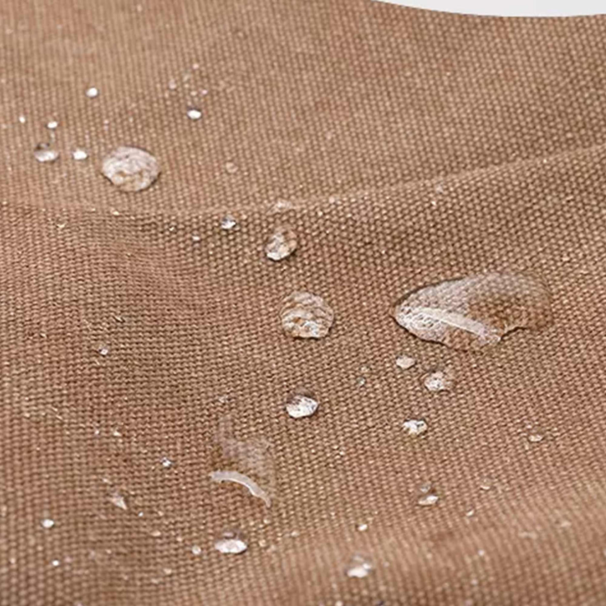 Water beading on the treated canvas of the Grant crossbody bag