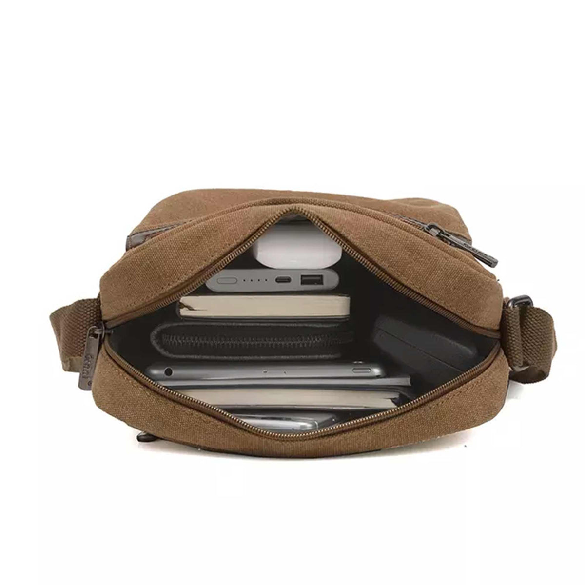 Grant compact canvas crossbody bag open at the top zip with a phone and a tablet inside
