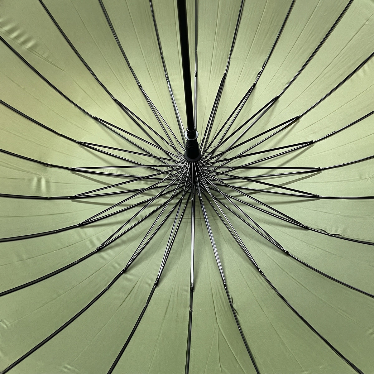 Underside of the open green Ezzyrol Sovereign canopy, showing the 24 panel ribbed frame