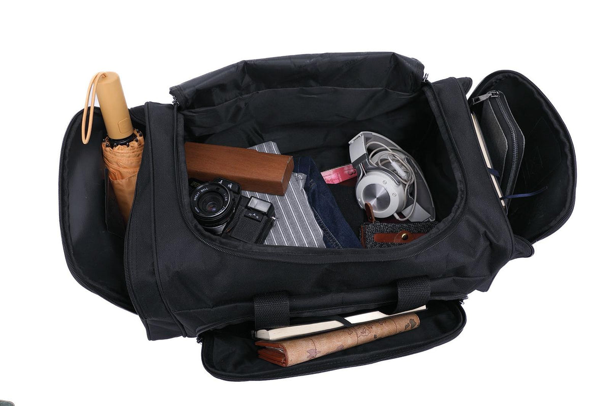 JustPack duffel holdall open and packed with an umbrella, a camera, folded clothes and toiletries