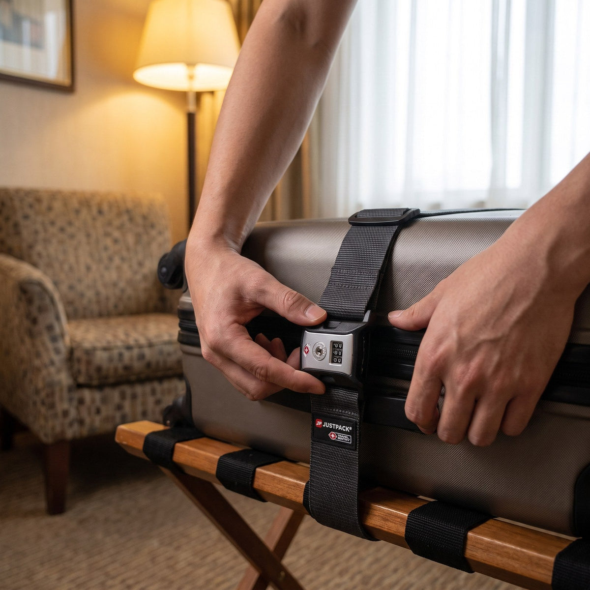 JUSTPACK Cinch luggage strap with TSA lock in charcoal grey, arriving at the hotel