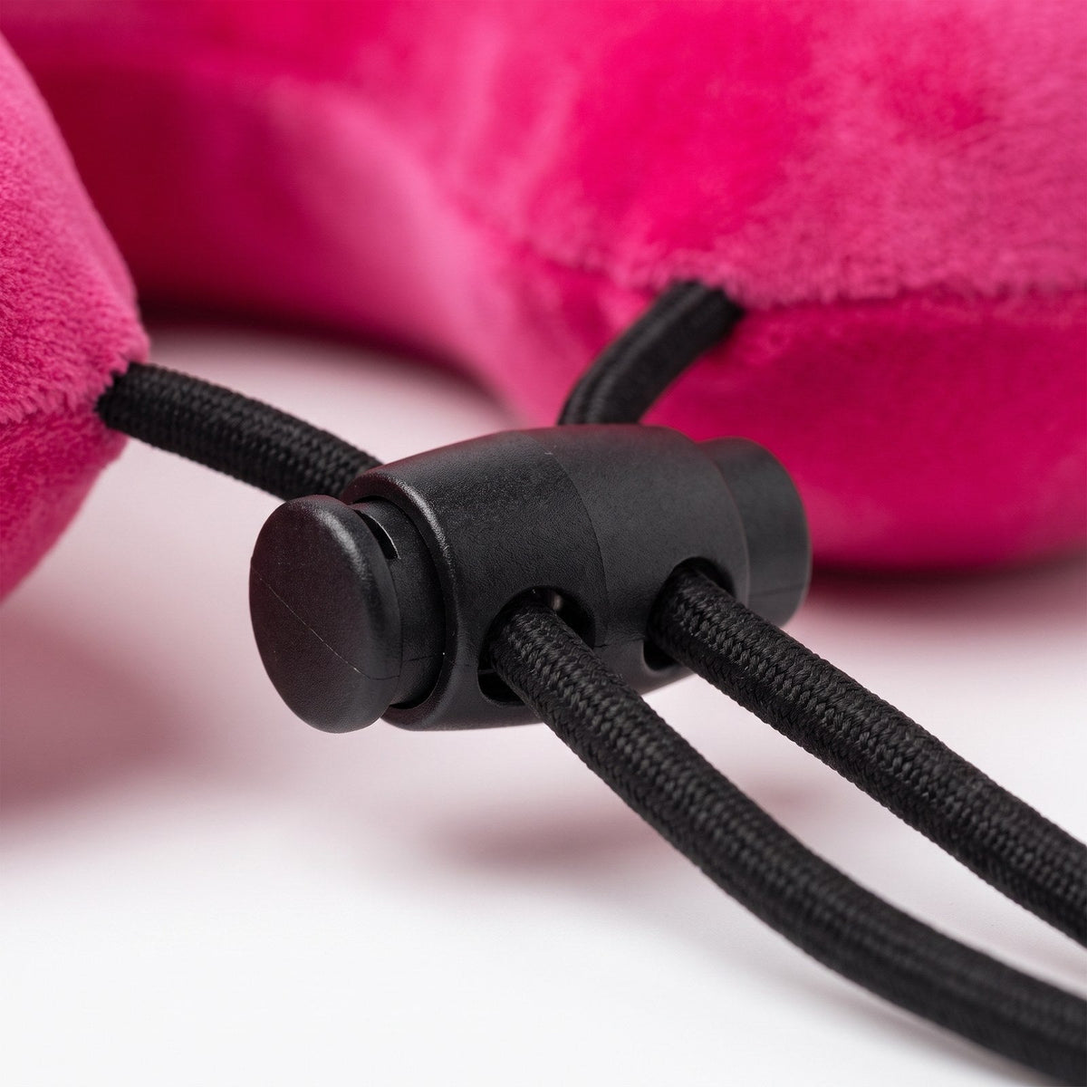 JUSTPACK Drift travel neck pillow in hot pink, cord lock mechanism