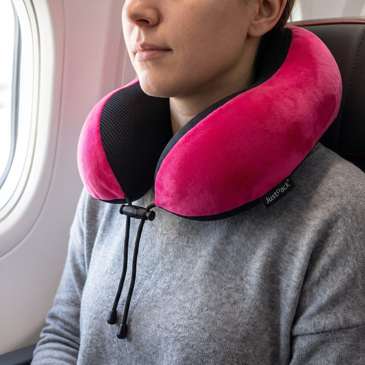 JUSTPACK Drift travel neck pillow in hot pink, in use neck support