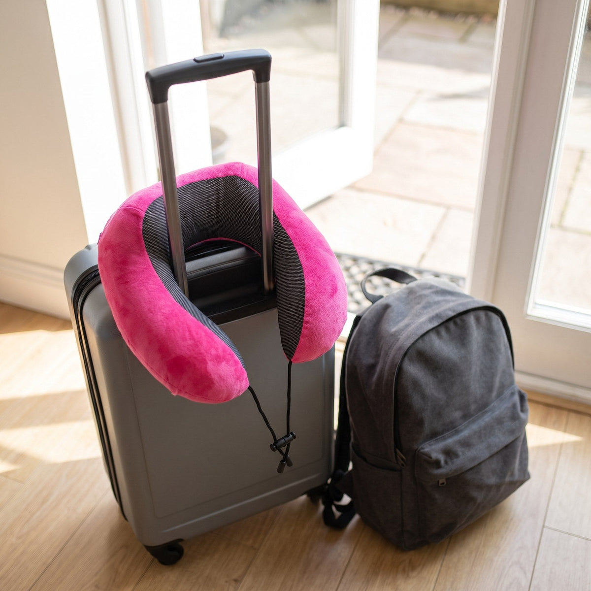 JUSTPACK Drift travel neck pillow in hot pink, packed and ready to go