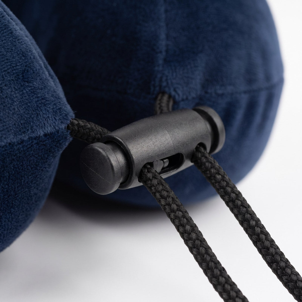 JUSTPACK Drift travel neck pillow in navy blue, hardware and cord lock