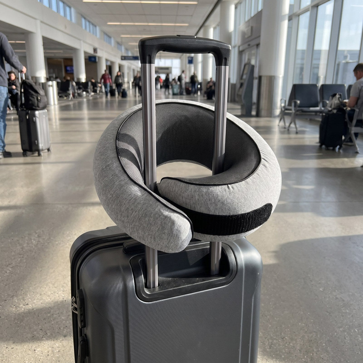 JUSTPACK Doze travel neck pillow, in use attached to luggage