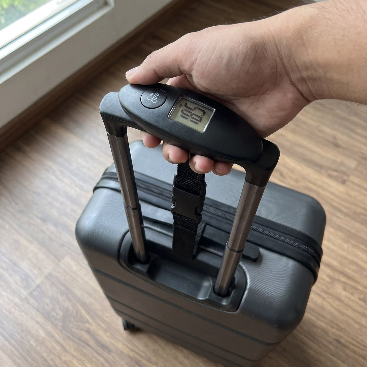 JUSTPACK Gauge digital luggage scale, in use weighing a suitcase