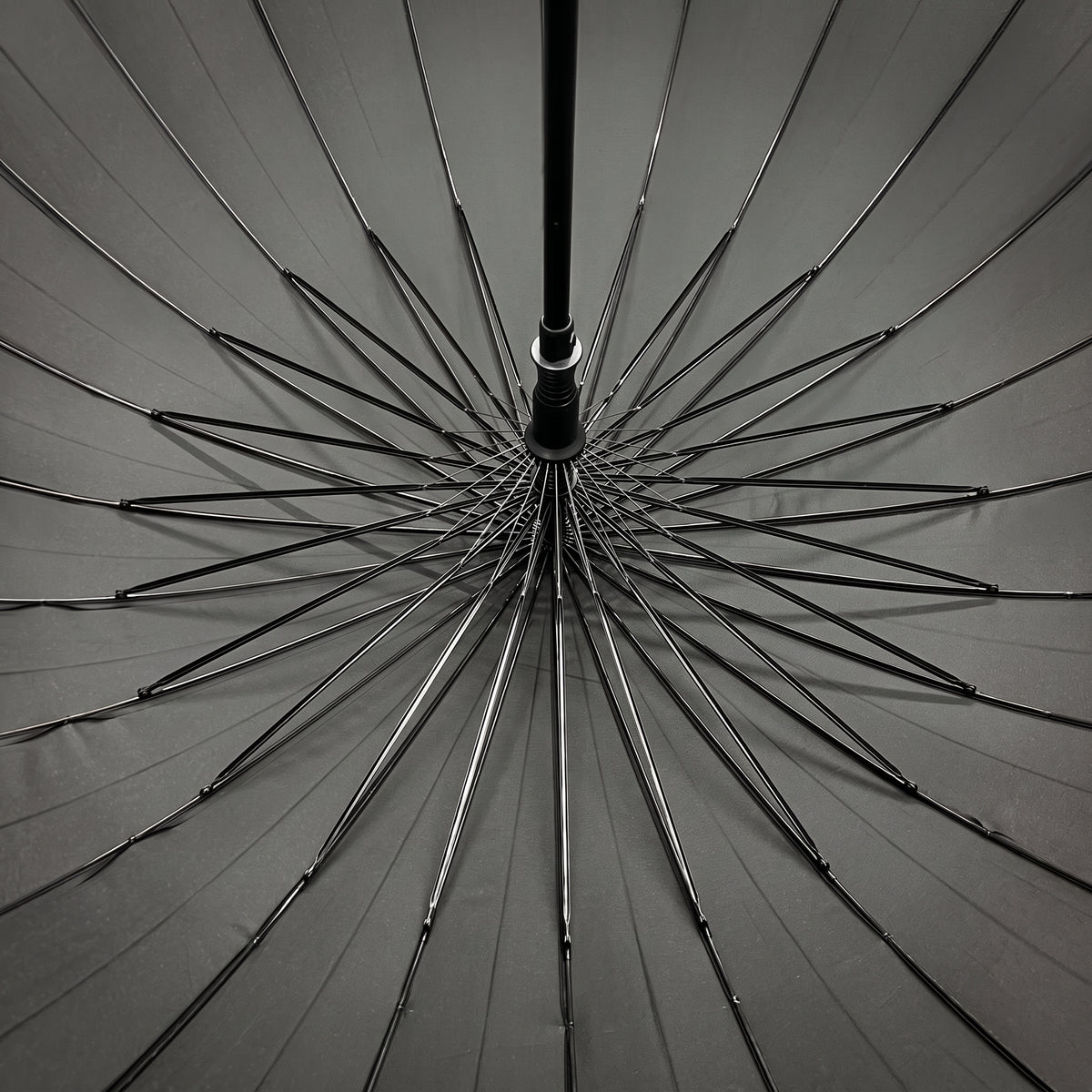 Underside of the open black Ezzyrol Sovereign canopy, showing the 24 panel ribbed frame