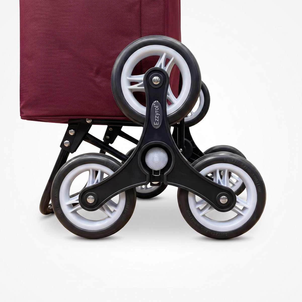 Close-up of the three wheel climbing cluster on the red Ezzyrol stair climber trolley