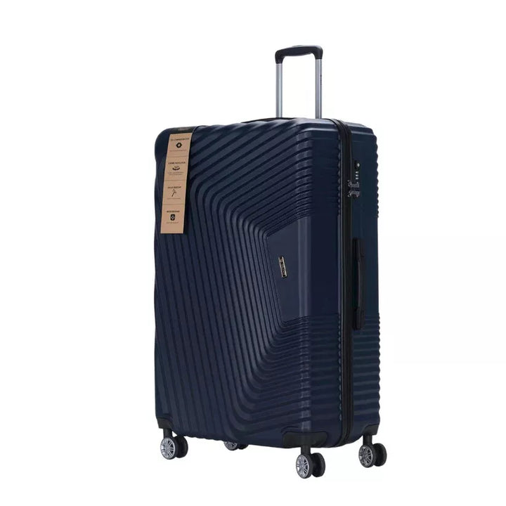 Navy ribbed hard shell suitcase on four double spinner wheels, three quarter view